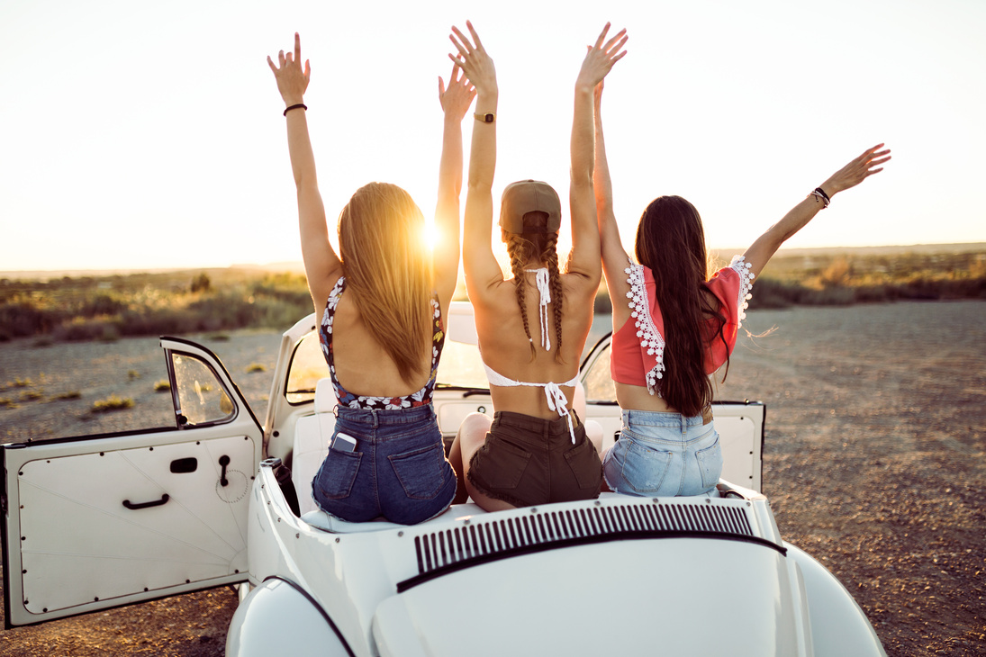 Young Women Driving on Road Trip